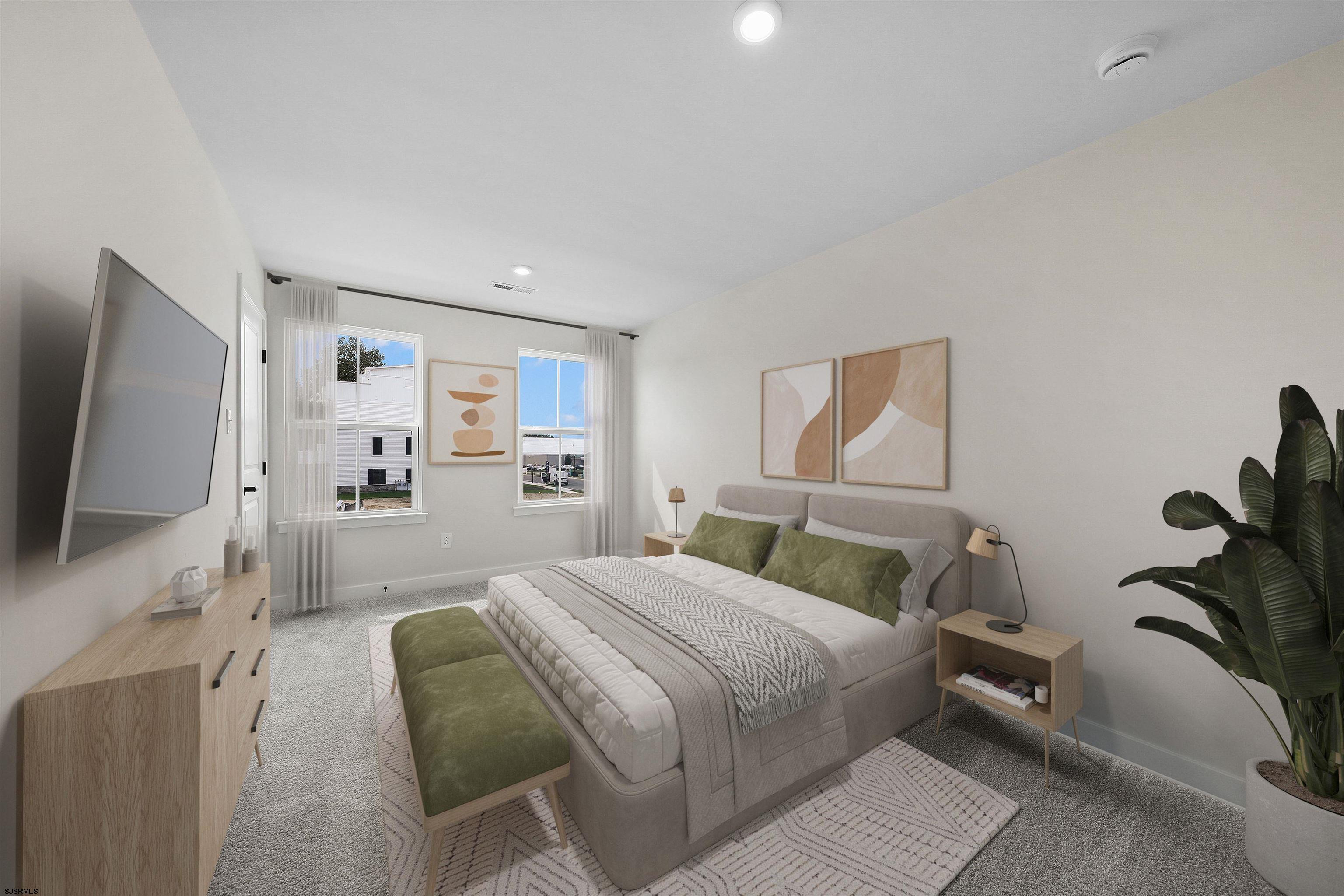 705 Jesse Drive, Unit 705 Somers Point, NJ 08244 - Photo 14 of 15 a bedroom with a large bed and a flat tv screen on dresser