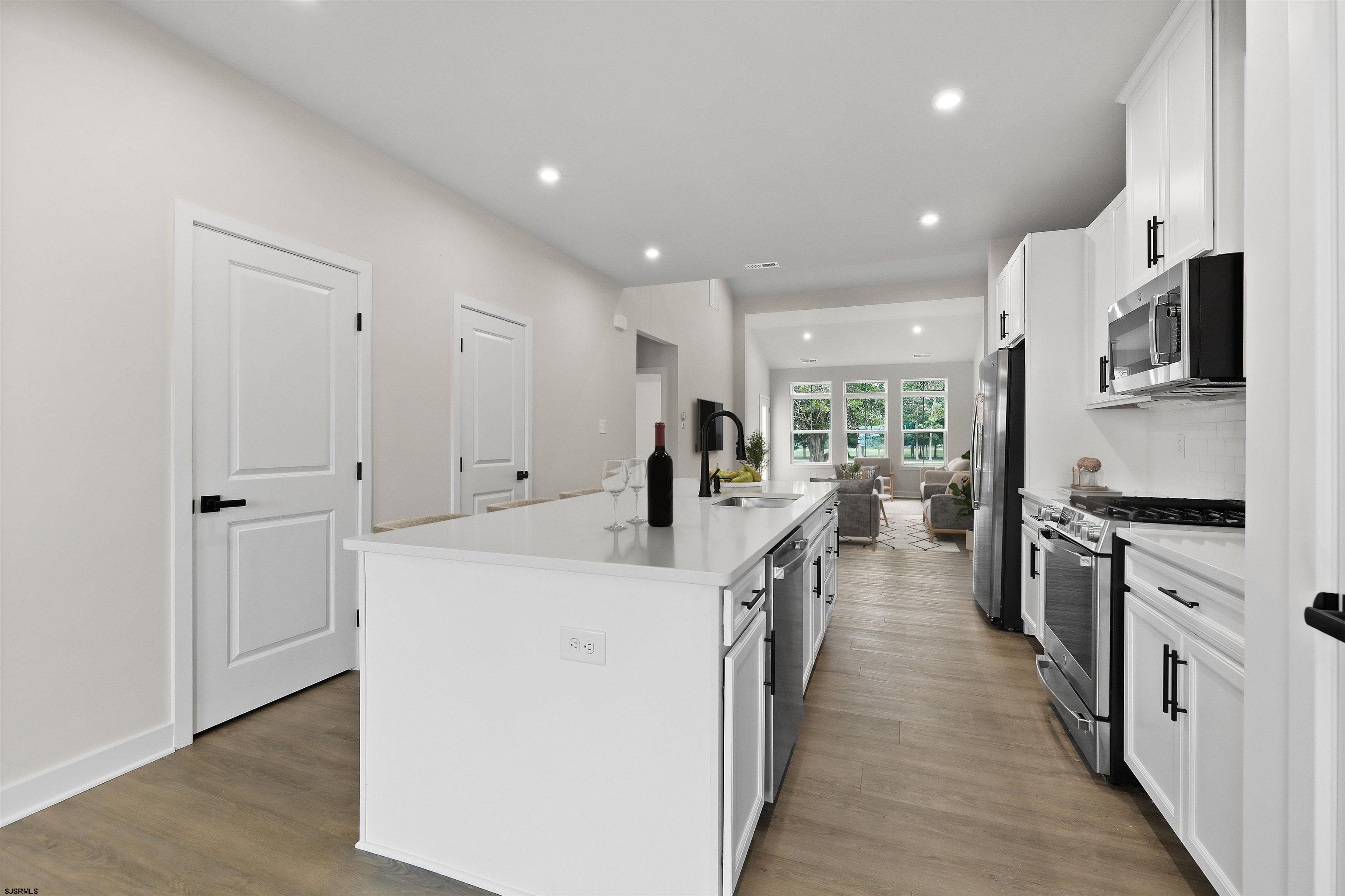 705 Jesse Drive, Unit 705 Somers Point, NJ 08244 - Photo 4 of 15 a large kitchen with stainless steel appliances a large counter top a stove and a refrigerator