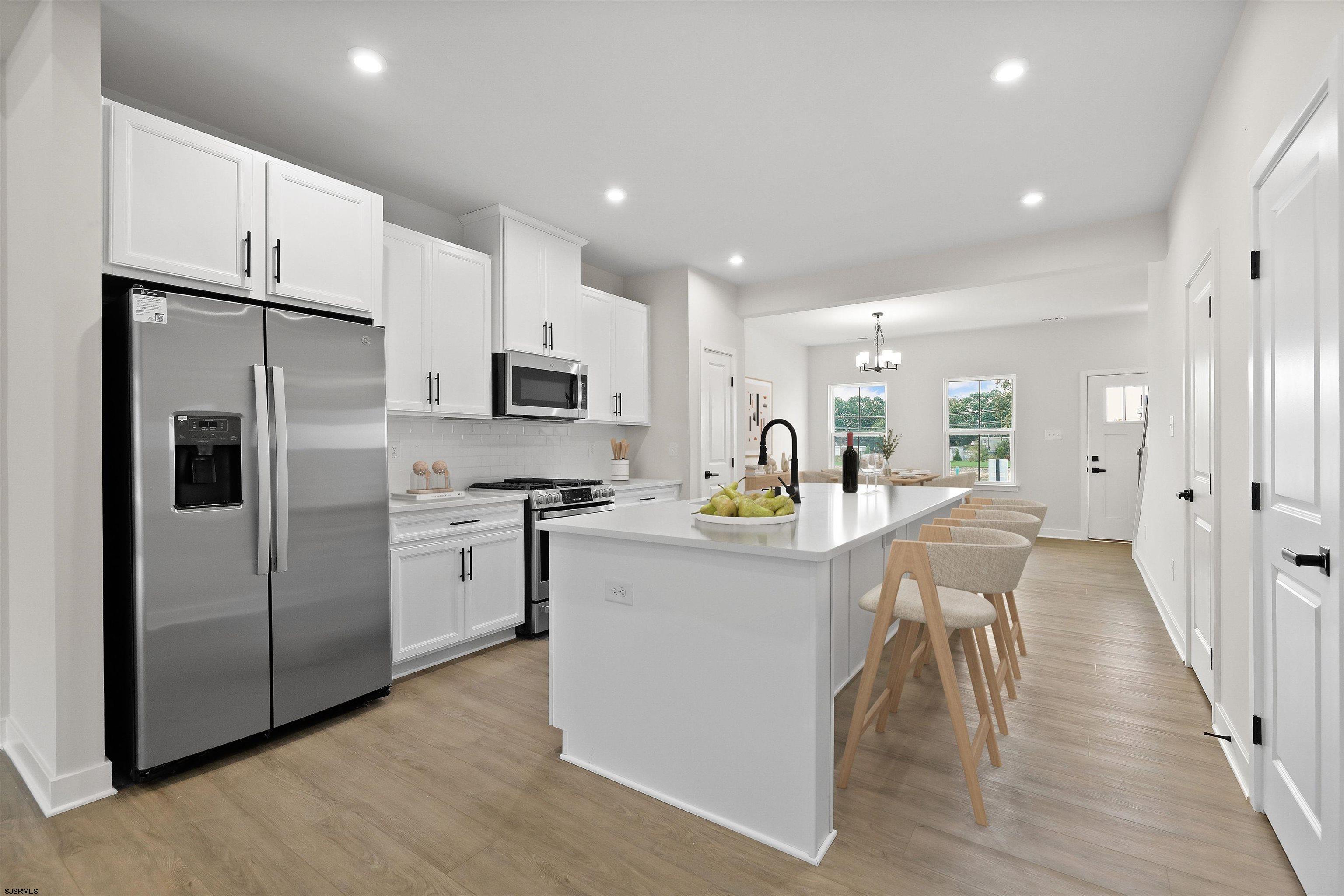 705 Jesse Drive, Unit 705 Somers Point, NJ 08244 - Photo 5 of 15 a kitchen with refrigerator and cabinets
