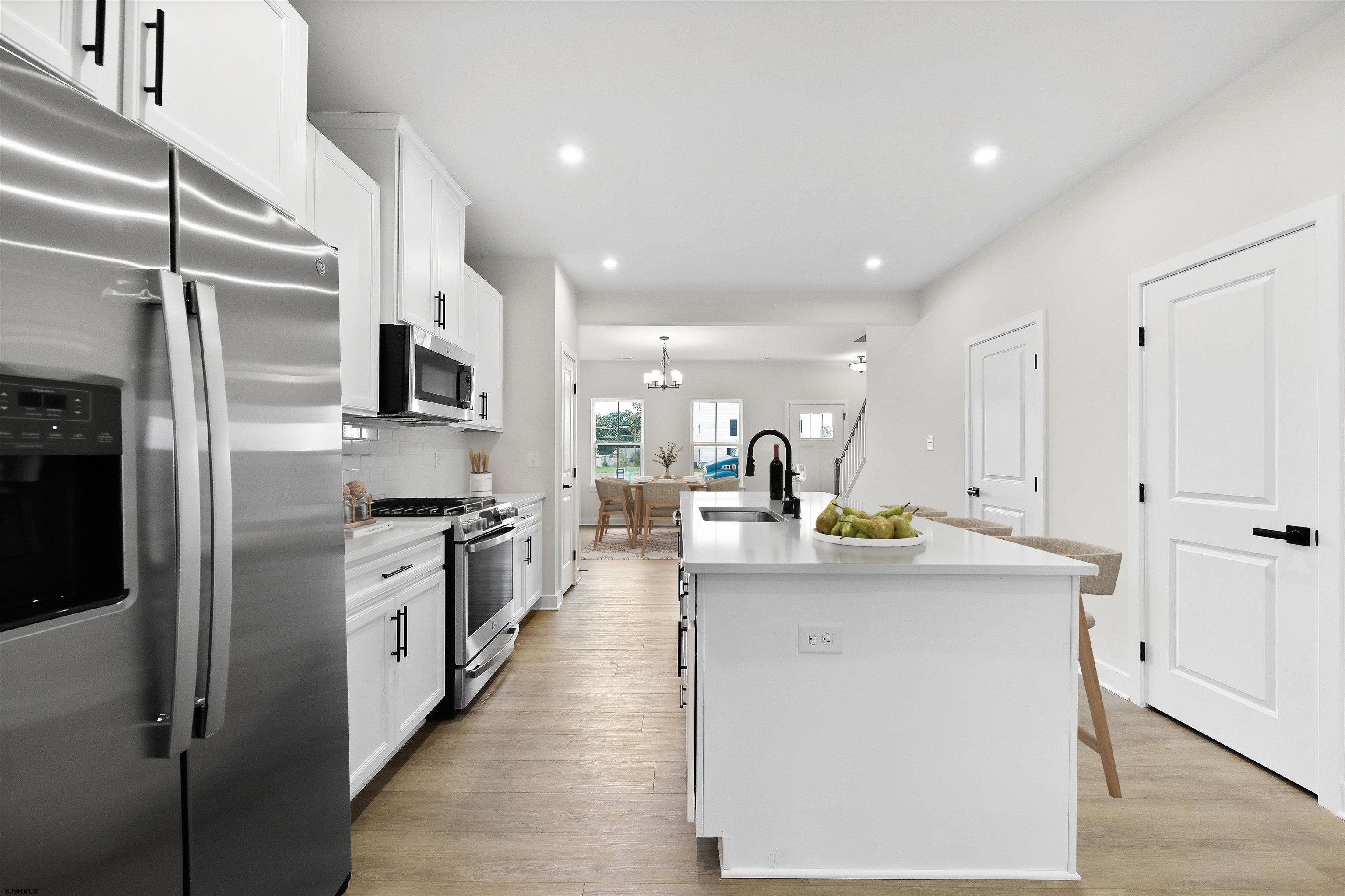 705 Jesse Drive, Unit 705 Somers Point, NJ 08244 - Photo 6 of 15 a kitchen with stainless steel appliances granite countertop a sink a stove and a refrigerator