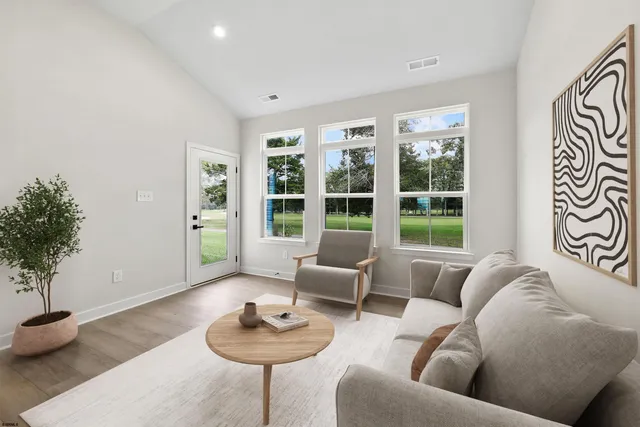 a living room with furniture and a potted plant