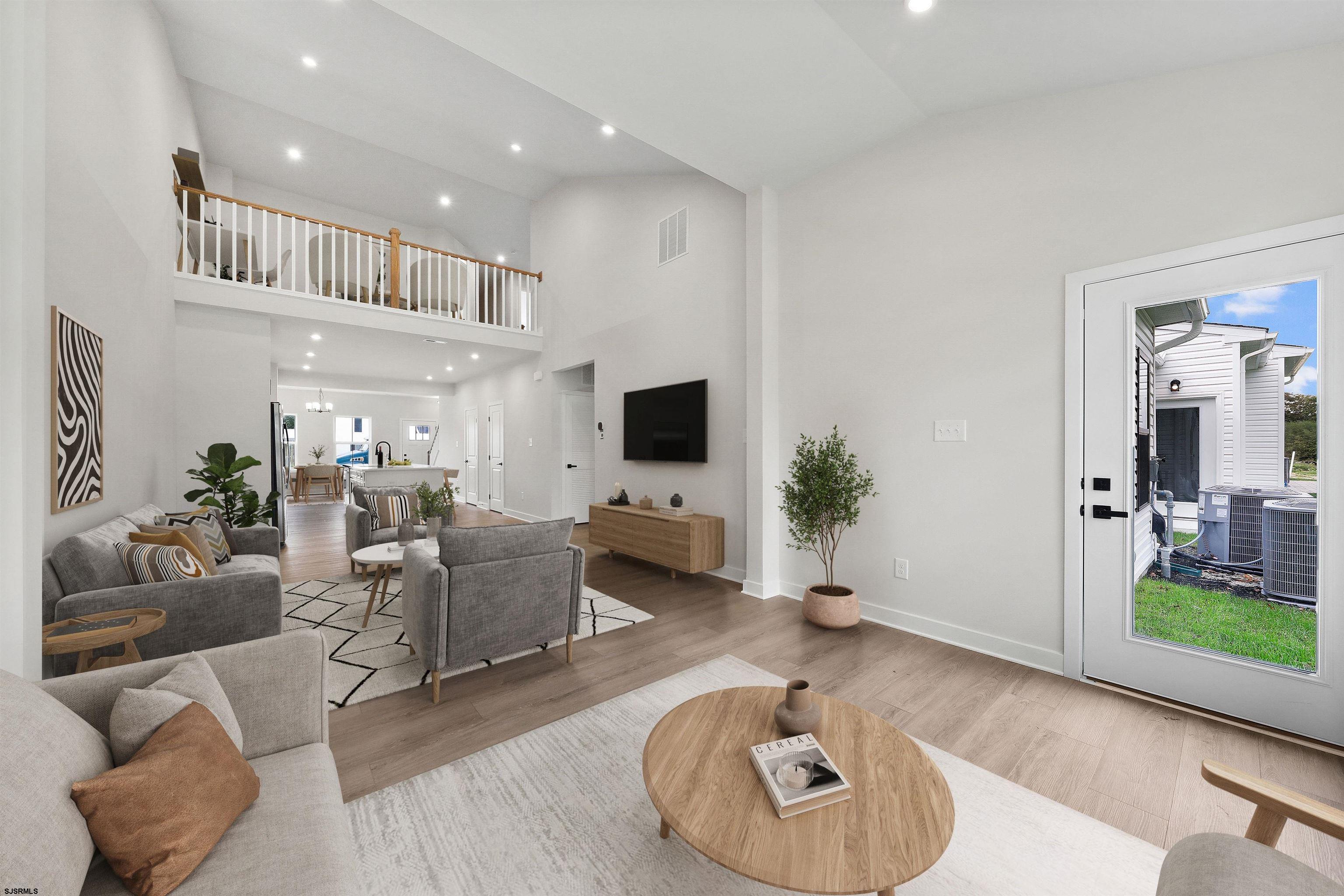 705 Jesse Drive, Unit 705 Somers Point, NJ 08244 - Photo 9 of 15 a living room with furniture and a flat screen tv