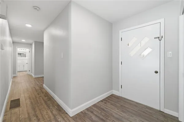 a view of hallway with wooden floor
