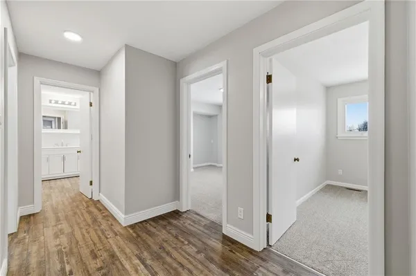 a view of hallway with wooden floor