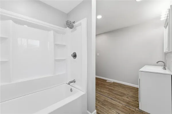 a bathroom with a bathtub and a sink