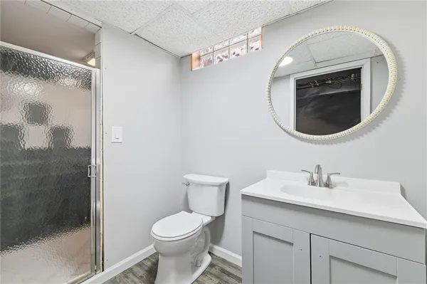 a bathroom with a sink a toilet and a mirror