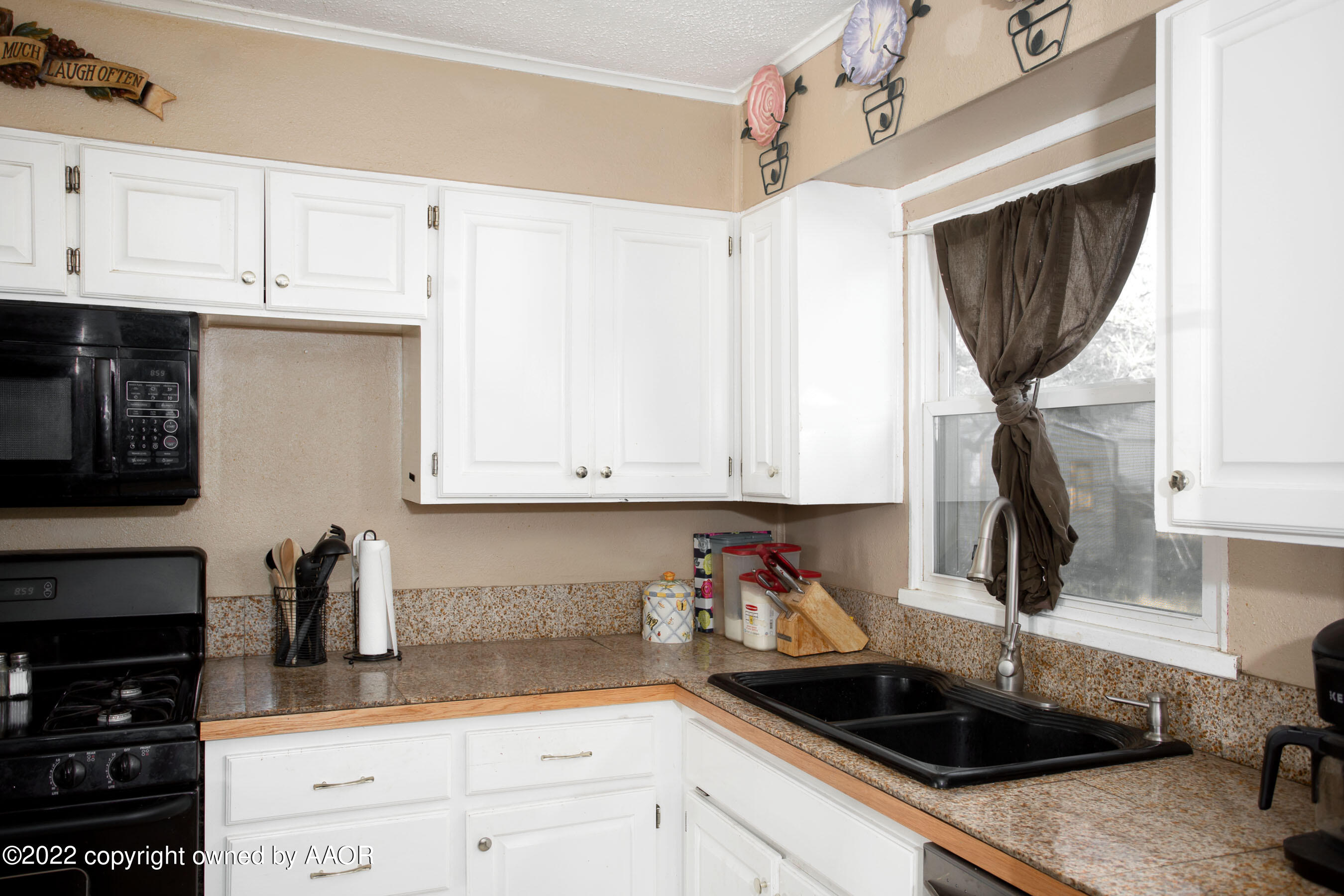 5310 Tumbleweed Drive Amarillo, TX 79110 - Photo 12 of 23 a kitchen with granite countertop a sink a stove and cabinets
