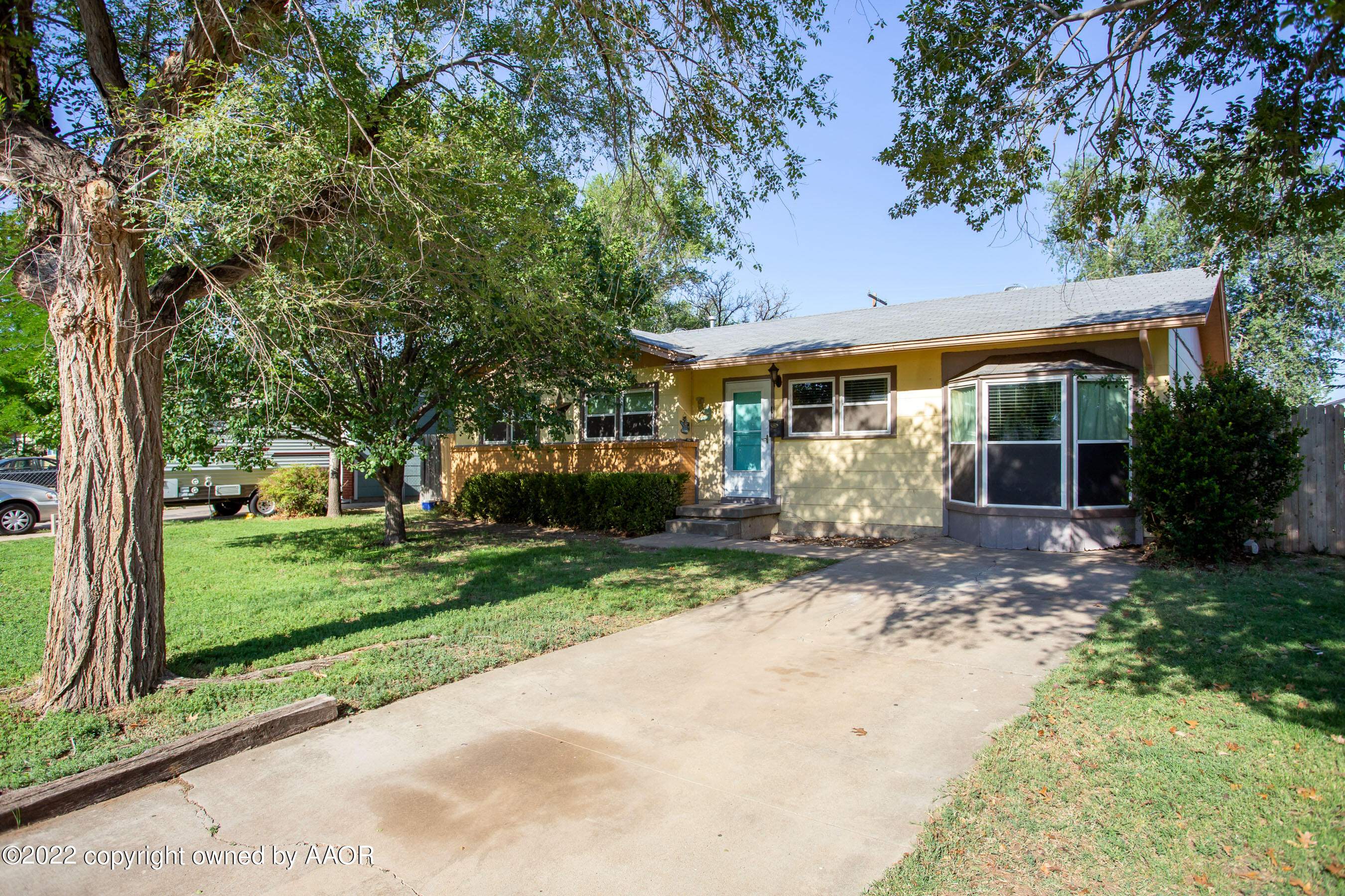 5310 Tumbleweed Drive Amarillo, TX 79110 - Photo 3 of 23 a front view of a house with a yard and garage