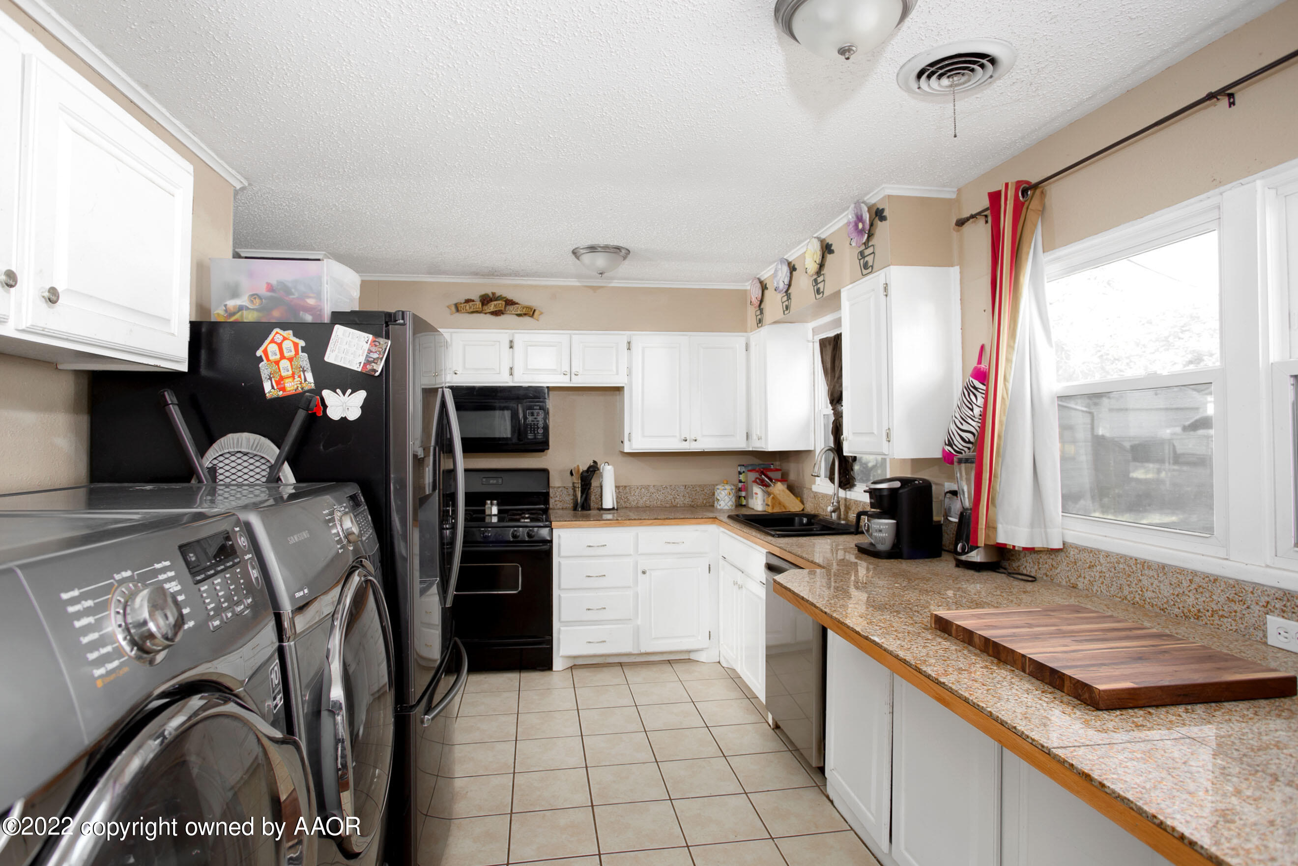 5310 Tumbleweed Drive Amarillo, TX 79110 - Photo 10 of 23 a kitchen with stainless steel appliances granite countertop a sink stove and refrigerator