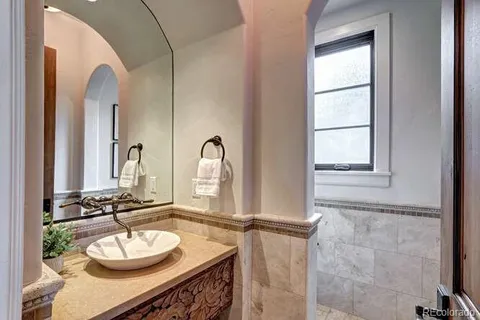 a bathroom with a sink a mirror and a window