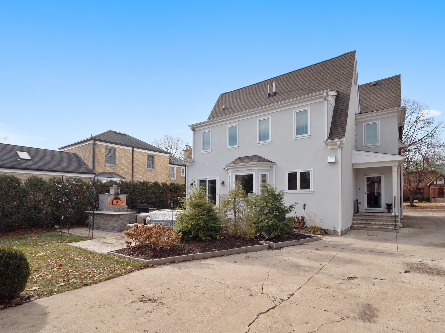 611 Wisner Street Park Ridge, IL 60068 - Photo 33 of 36 a view of a white house with plants next to road