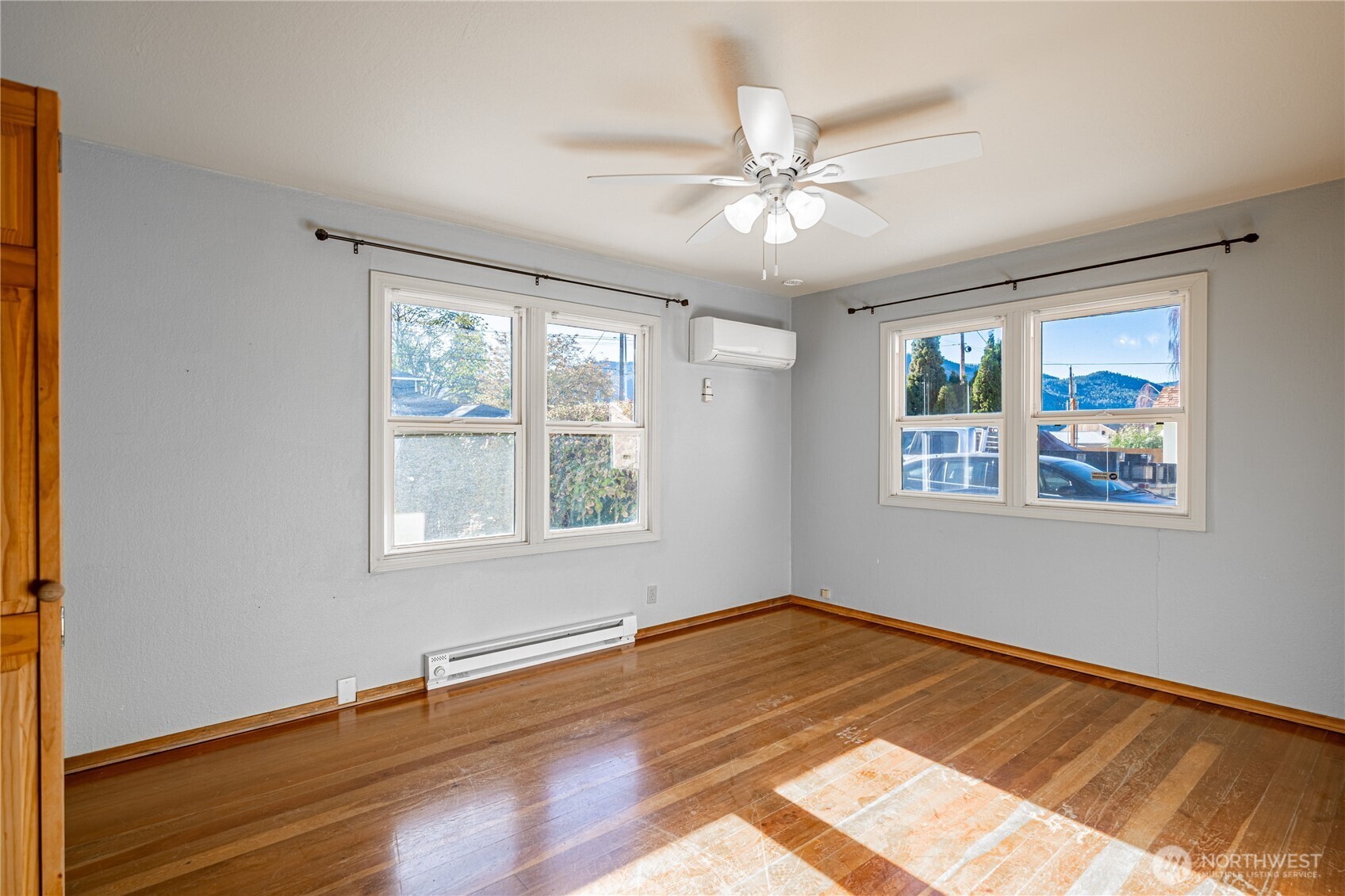 145 North Harris Avenue Manson, WA 98831 - Photo 11 of 28 a view of an empty room with wooden floor and a window