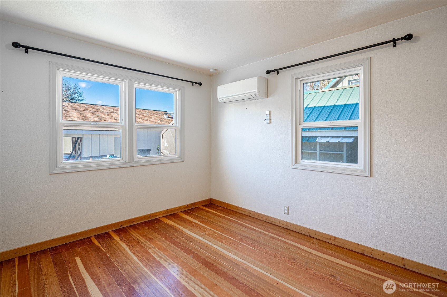 145 North Harris Avenue Manson, WA 98831 - Photo 13 of 28 a view of a room with wooden floor and windows