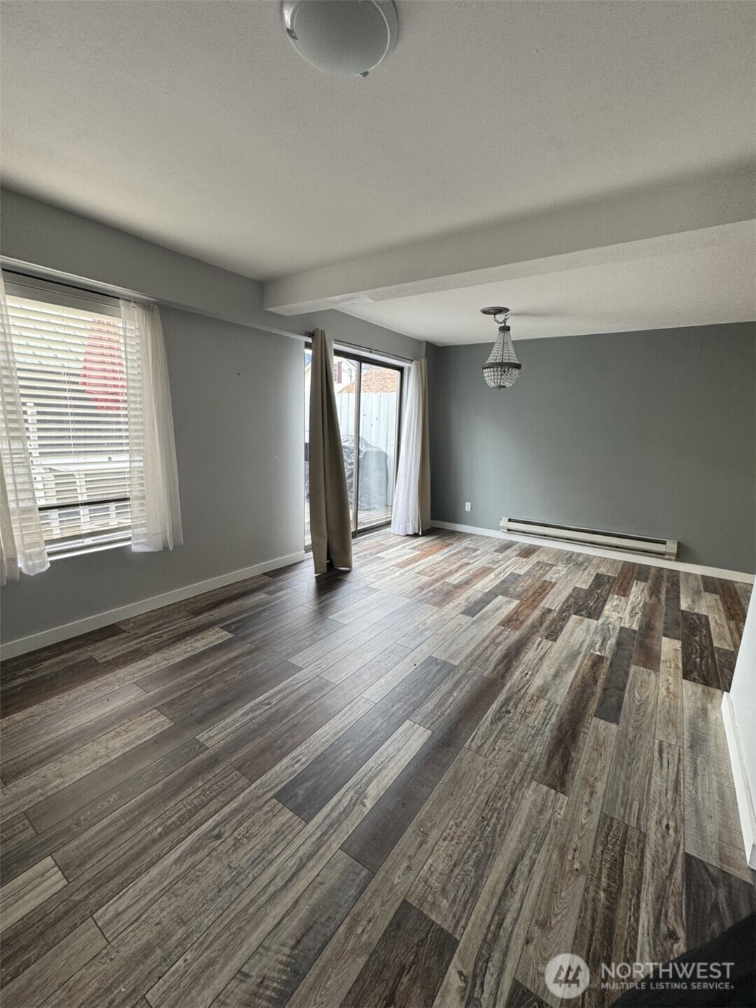 145 North Harris Avenue Manson, WA 98831 - Photo 21 of 28 a view of an empty room with wooden floor and a window