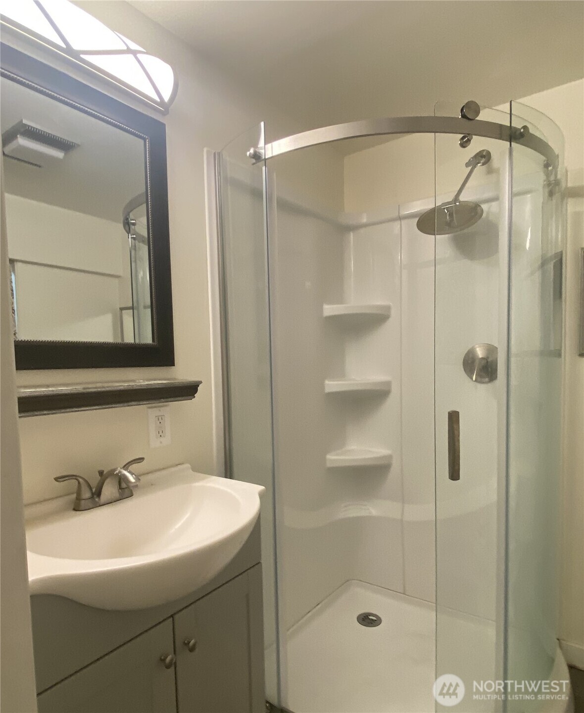 145 North Harris Avenue Manson, WA 98831 - Photo 24 of 28 a bathroom with a shower sink and mirror