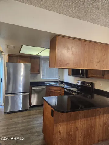 a kitchen with a sink stove and refrigerator