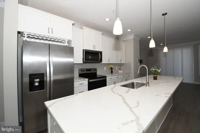 a view of a big room with wooden floor and a window