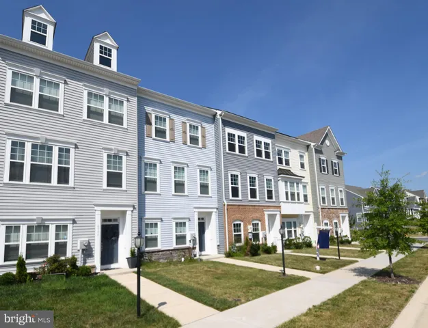 a front view of a building with a garden