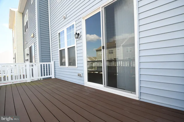an empty room with wooden floor and entrance