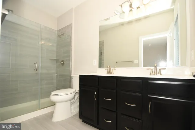 an empty room with wooden floor and window