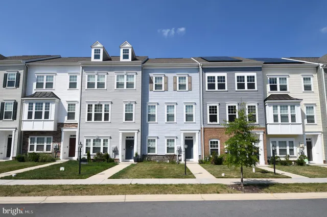 a front view of a residential apartment building with a yard