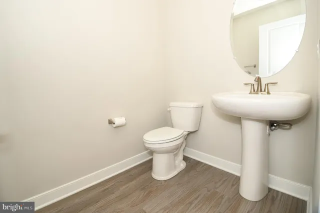 a bathroom with a toilet a sink and a mirror