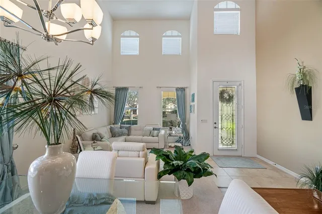 a living room with furniture and a chandelier