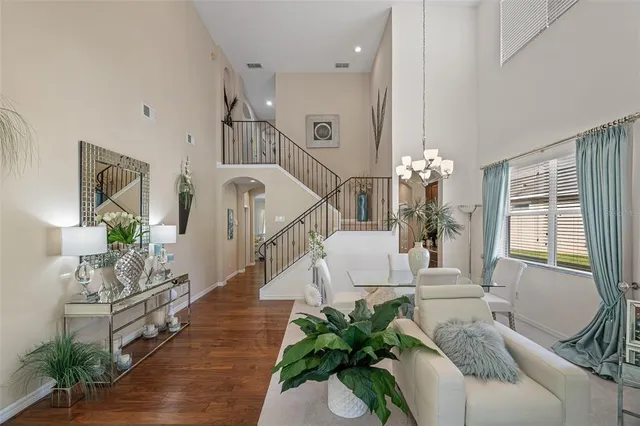 a living room with furniture flat screen tv and wooden floor
