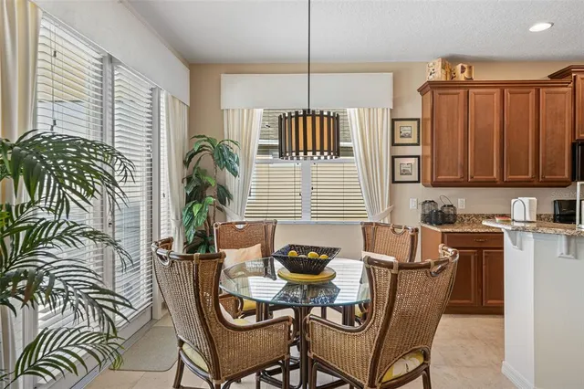 a living room with furniture a fireplace and a kitchen view