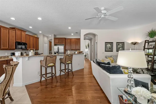 a kitchen with kitchen island granite countertop a refrigerator oven a sink and dishwasher