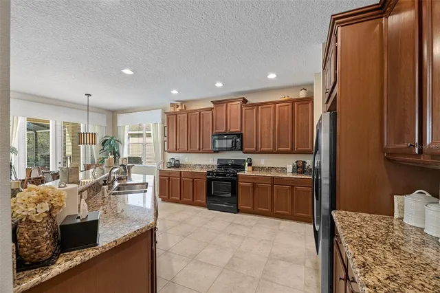 a kitchen with sink and refrigerator