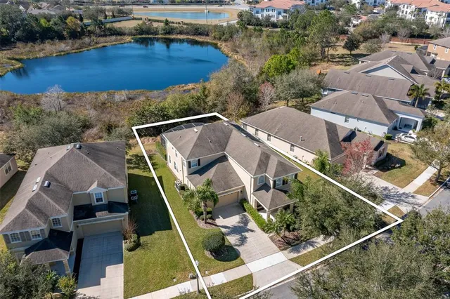 an aerial view of residential houses with outdoor space and swimming pool
