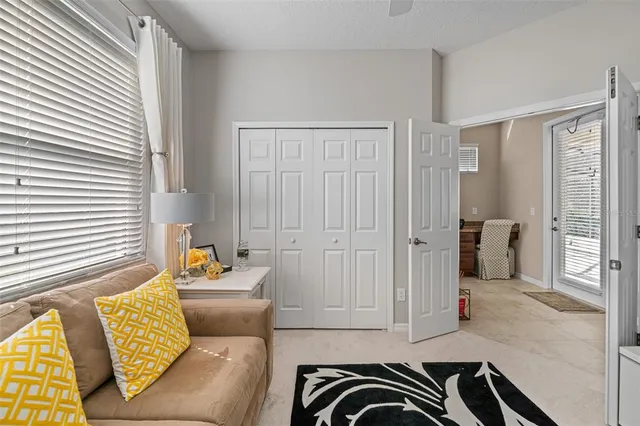a living room with furniture chandelier and wooden floor
