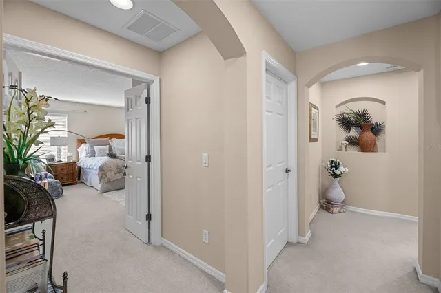 a bedroom with bed and a chandelier