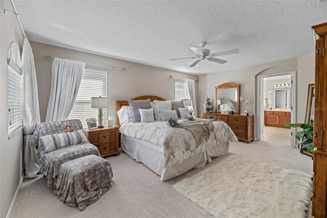 a bedroom with furniture and a large window