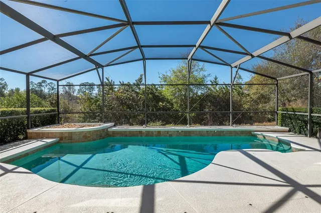 a view of a yard with table and chairs under an umbrella