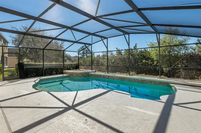 a view of a patio with table and chairs under an umbrella