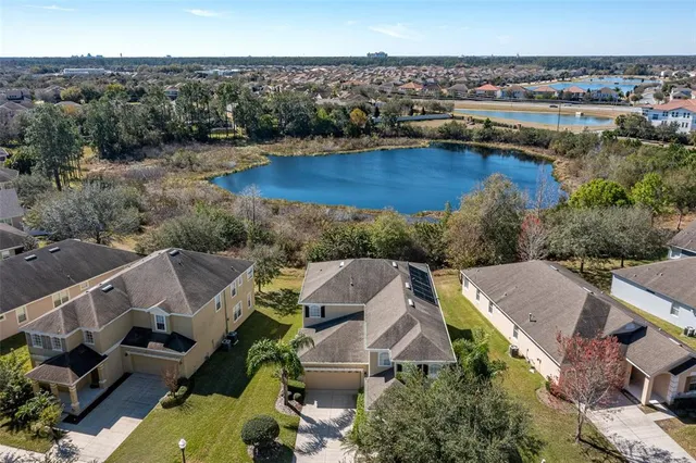 an aerial view of house with yard and ocean view