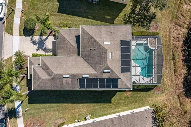 an aerial view of a house with a yard