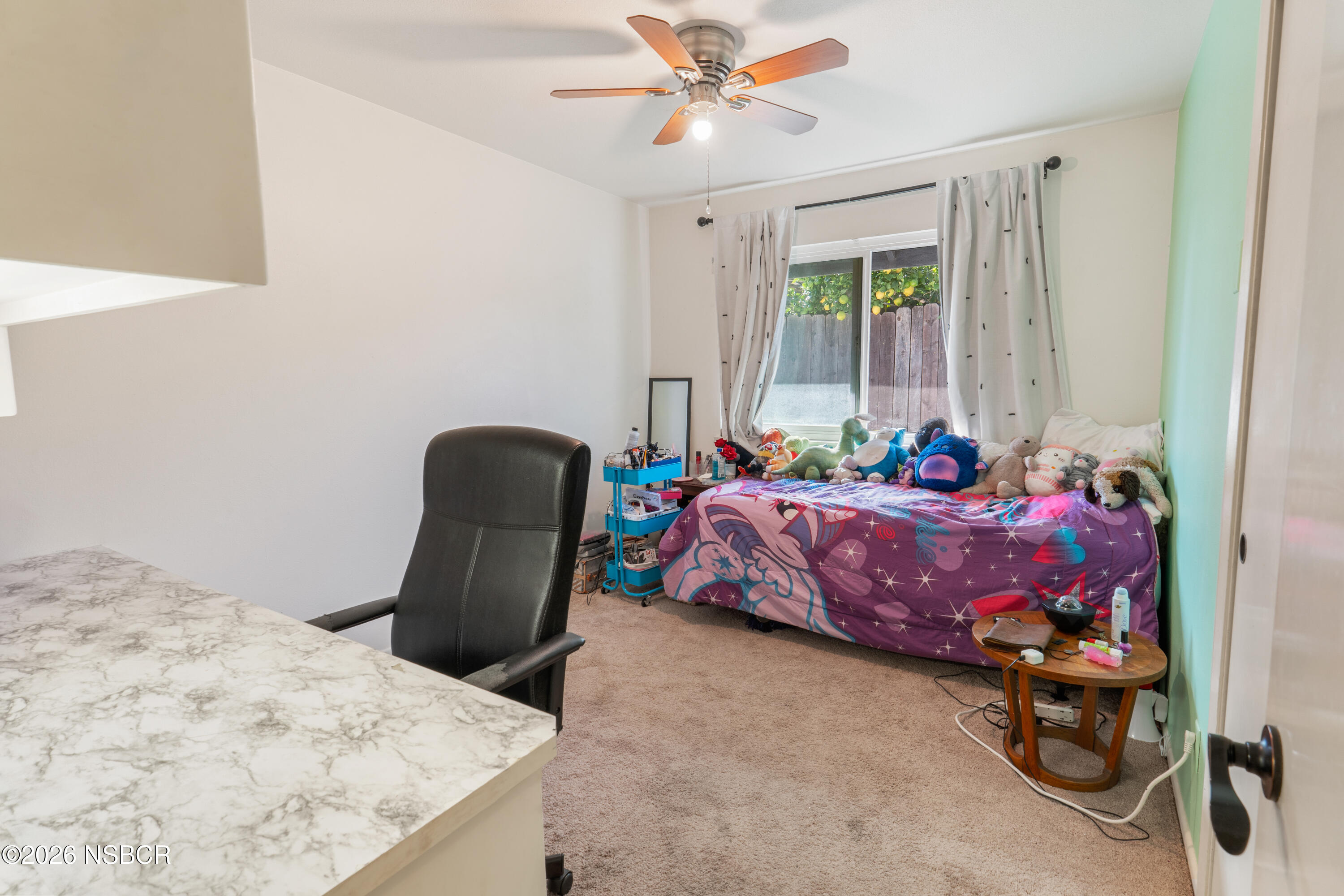 4220 Constellation Road Lompoc, CA 93436 - Photo 11 of 22 a bedroom with a bed and a chair
