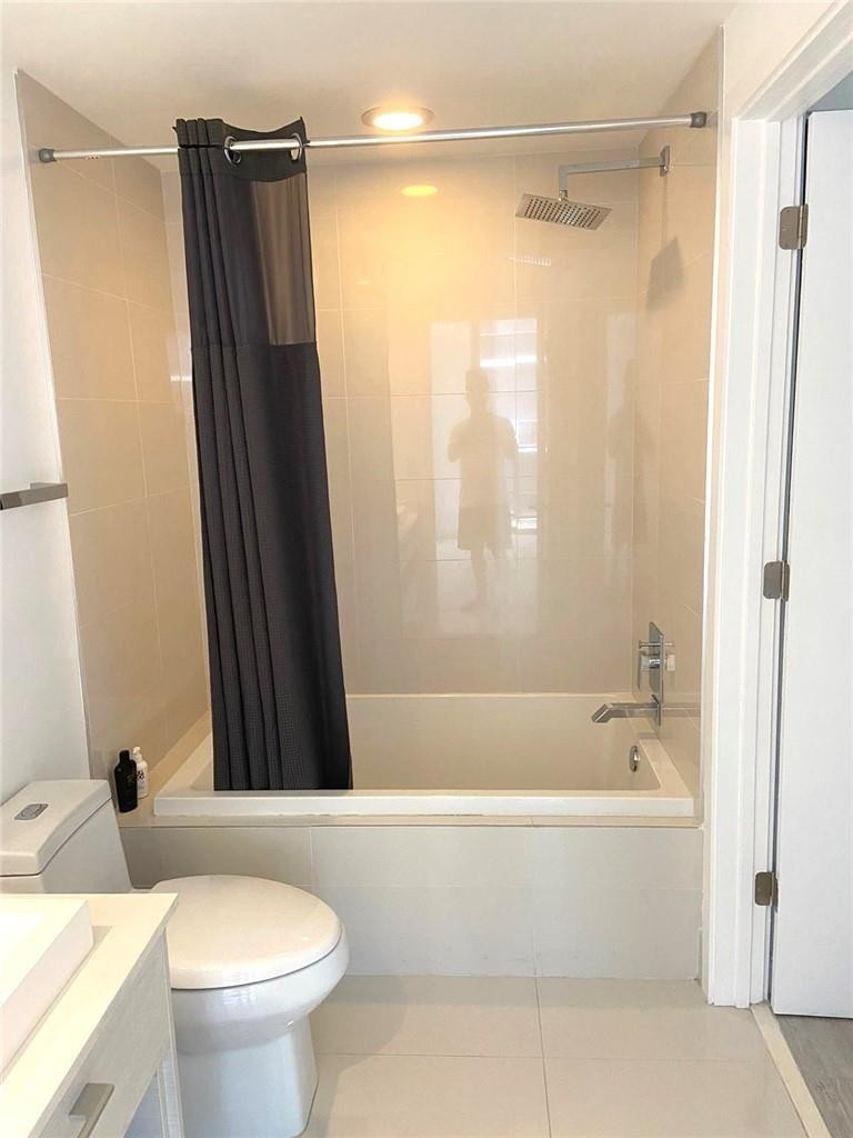 45 Southwest 9th Street, Unit 3707 Miami, FL 33130 - Photo 11 of 29 a bathroom with a shower and a toilet