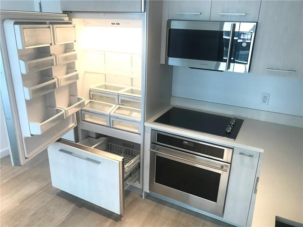 45 Southwest 9th Street, Unit 3707 Miami, FL 33130 - Photo 25 of 29 a kitchen with a stove and a microwave