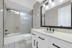 a bathroom with a double vanity sink toilet mirror and shower