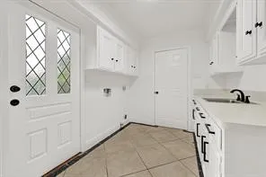 a view of a kitchen with white cabinets and wooden floor