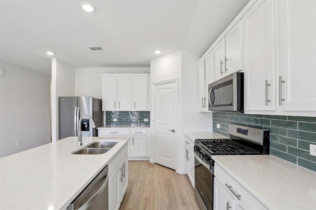 2100 Rannoch Street Sherman, TX 75092 - Photo 3 of 11 a kitchen with a sink stove top oven and refrigerator