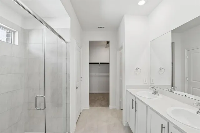 a bathroom with a double vanity sink a and mirror
