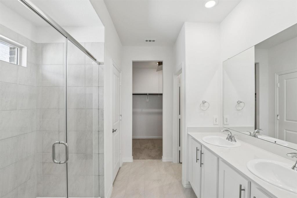 2100 Rannoch Street Sherman, TX 75092 - Photo 9 of 11 a bathroom with a double vanity sink a and mirror