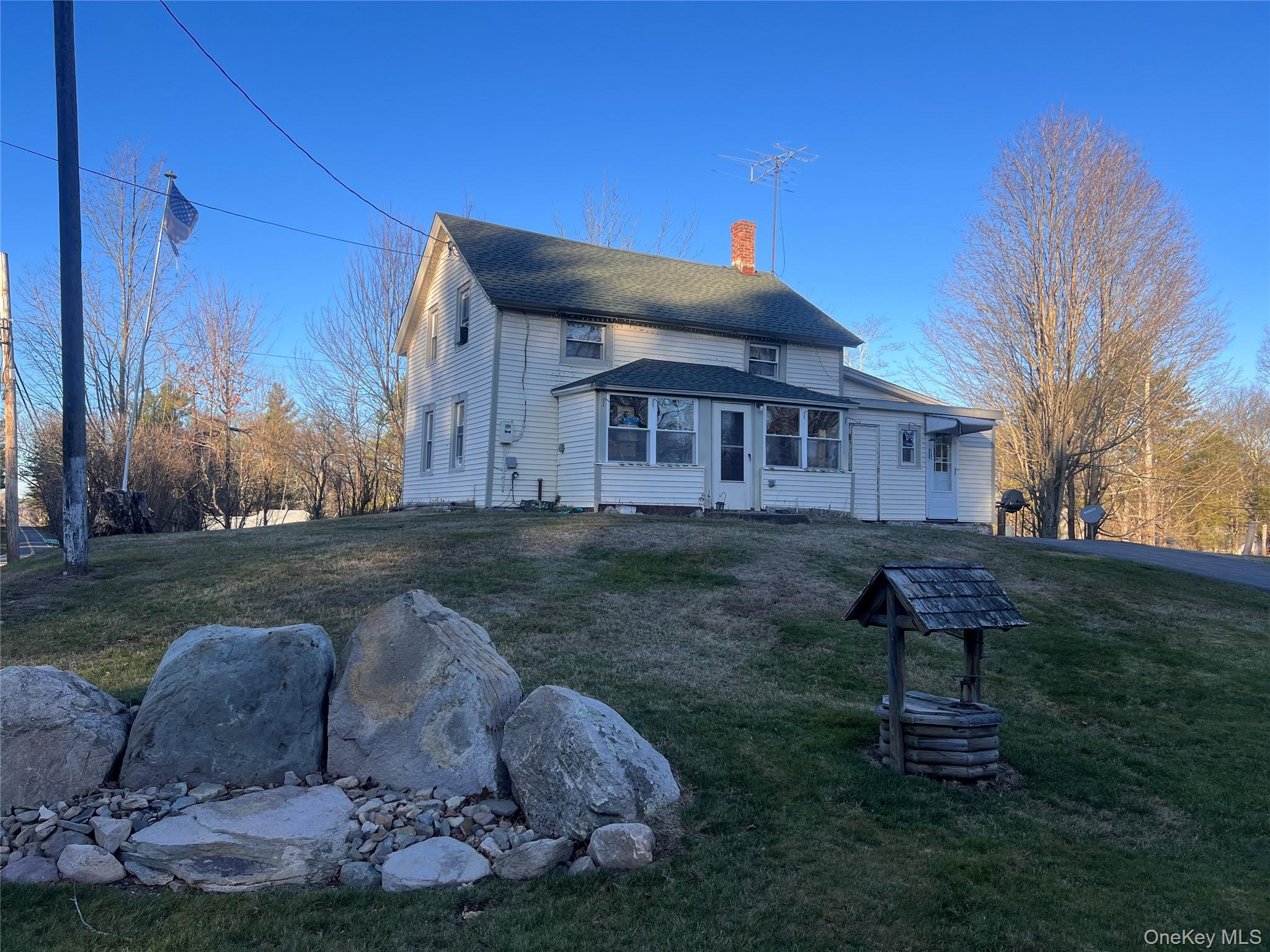 279 Cold Spring Road Monticello, NY 12701 - Photo 2 of 32 Rear view of house with a lawn, a chimney, and a shingled roof