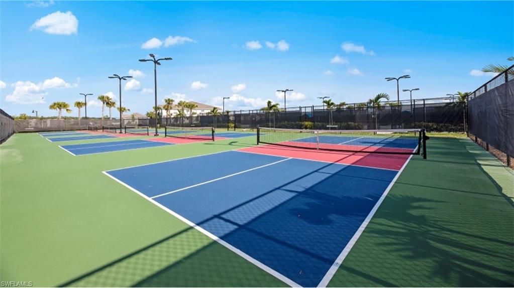 5583 Double Eagle Circle, Unit 4115 Ave Maria, FL 34142 - Photo 17 of 50 View of tennis court featuring basketball hoop