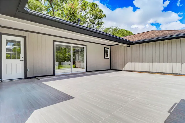 a front view of a house with a garden and yard